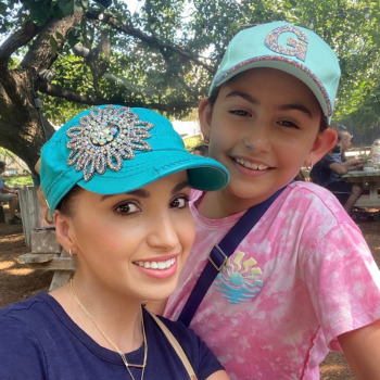 Headshot picture of Care Sidekick Gabriela Perez and daughter in blue hats, smiling